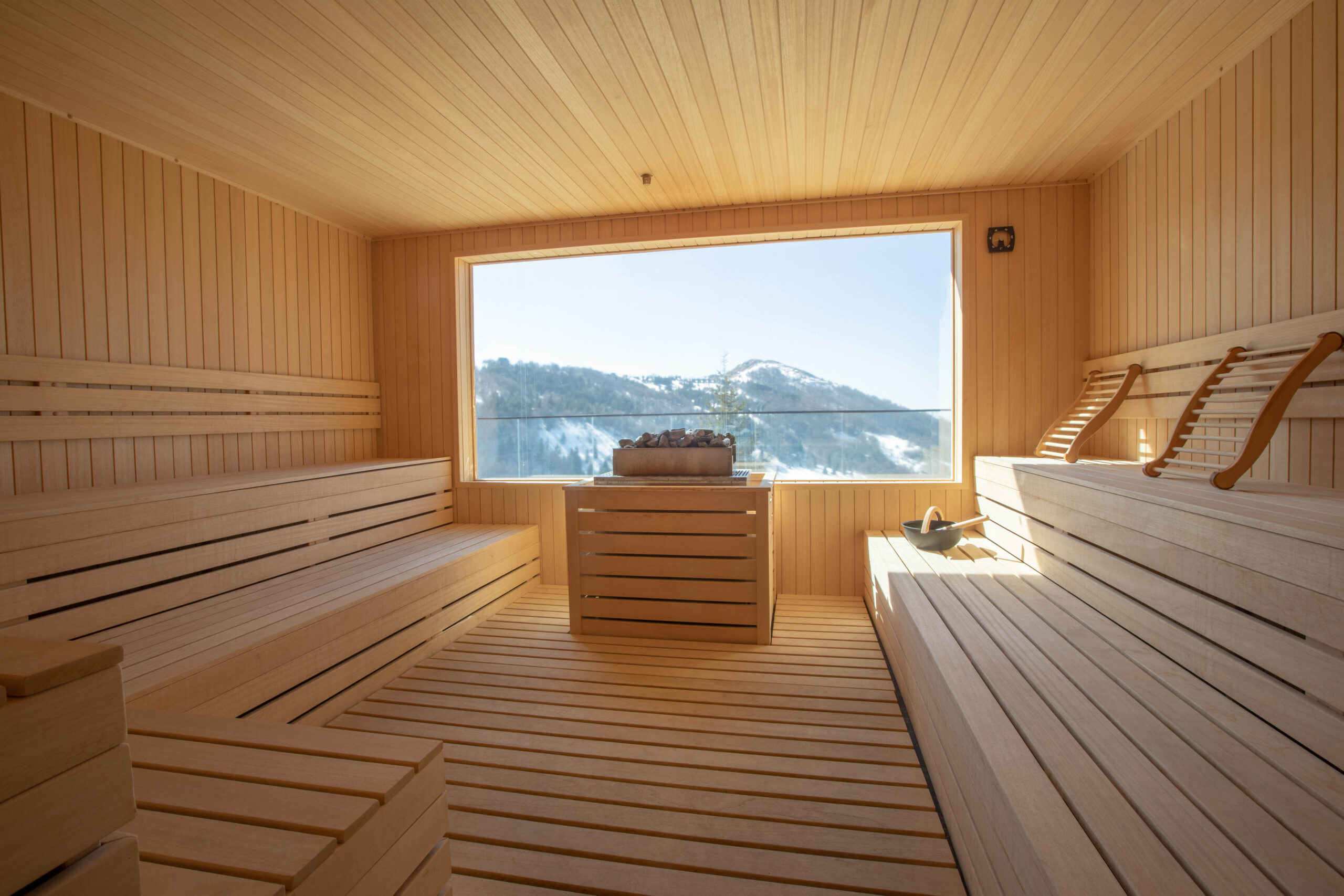 Empty wooden sauna room with traditional sauna accessories